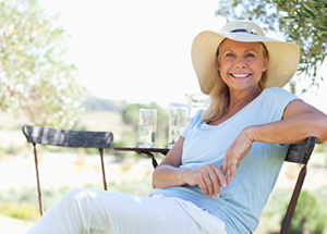 happy patient in sunhat relaxing in the shade in the countryside