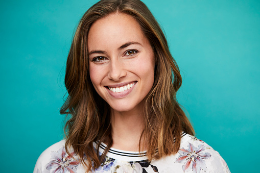 Young woman smiling after pinhole technique at Aesthetic Periodontal & Implant Specialists.