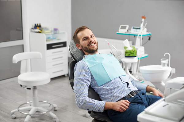 Smiling person in a dental chair.