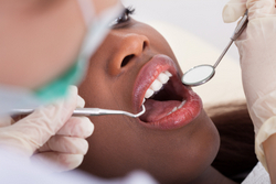 Patient with dentist in dental exam chair
